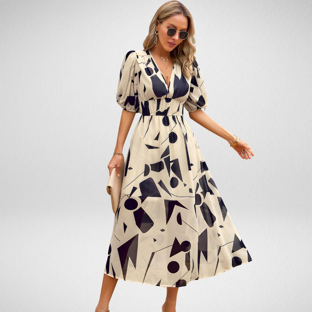 Vestido midi sofisticado con diseño de escote definido y mangas cortas con volumen y estampado abstracto