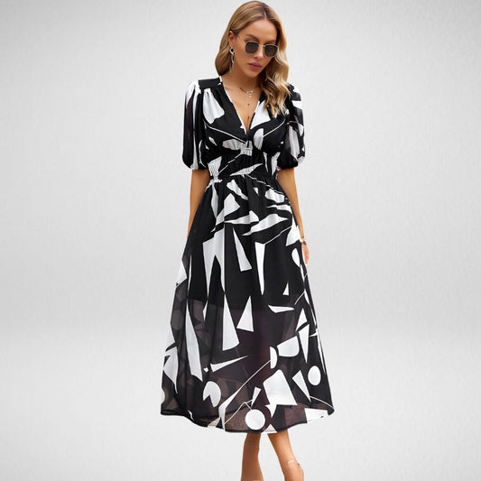 Vestido midi sofisticado con diseño de escote definido y mangas cortas con volumen y estampado abstracto